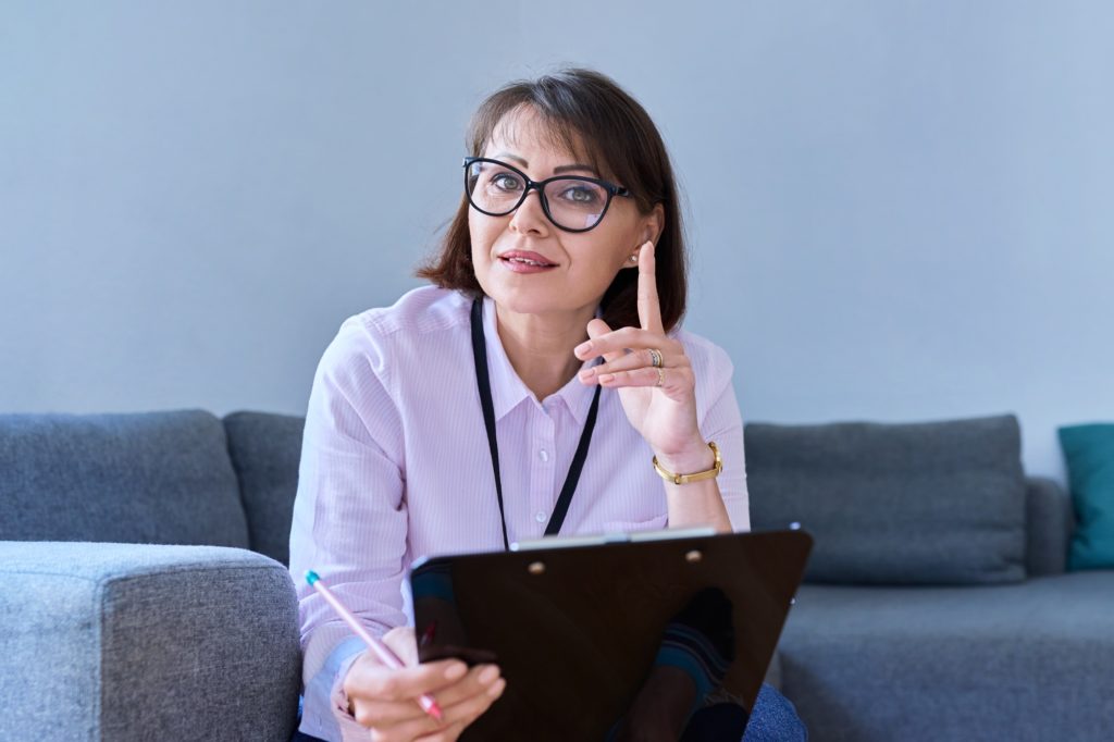 Portrait of female psychologist sitting on sofa in office